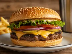 A double smash cheeseburger on a toasted potato bun, two lacy-edged patties with deep brown crusts and molten yellow American cheese draping over them.